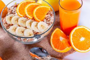 Food Photo of Healthy Breakfast including fresh Orange Juice and Muesli with Oranges and Banana