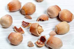 Forest nuts hazelnuts on white wooden background