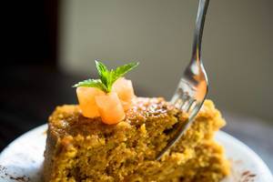 Fork inserted in a piece of carrot cake