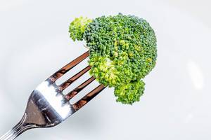 Fork with a piece of green broccoli