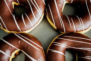 Four chocolate glazed doughnuts