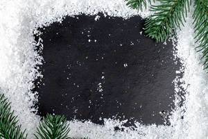 Frame of snow and Christmas tree branches on a black background (Flip 2019)
