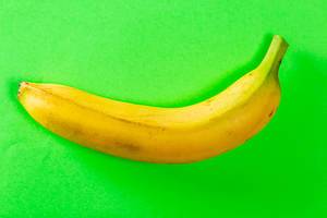Fresh banana on green background. Top view