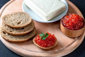 Fresh black bread, butter and red caviar