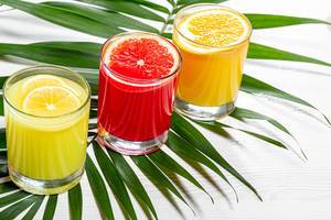 Fresh citrus juices with green leaf
