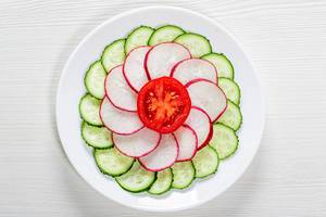 Fresh diet salad of cucumber, radish and tomato. Top view