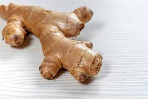 Fresh ginger root on white wooden background (Flip 2019)