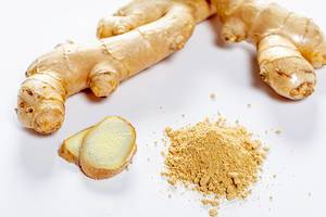 Fresh ginger root, slices and ground on white background
