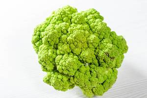 Fresh green broccoli on light wooden background