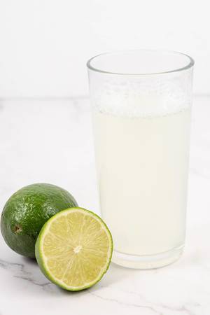 Fresh Green Limes juice on the white table (Flip 2019) (Flip 2019)