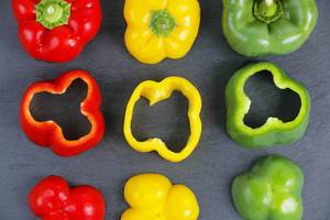 Fresh green, red and yellow pepper, black background (Flip 2019)