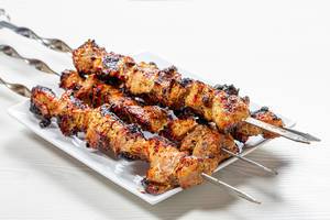 Fresh, home-cooked on the grill fire barbecue pork with skewers (Flip 2019)