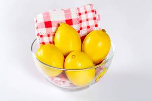 Fresh lemons in a glass bowl