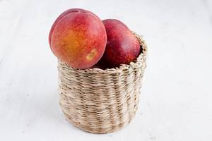 Fresh peach fruit in basket