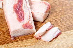 Fresh pork fat chopped on kitchen Board (Flip 2019)