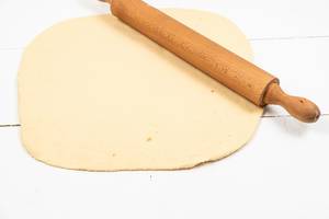 Fresh raw Dough with wooden Rolling Pin (Flip 2020)