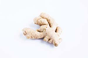 Fresh raw ginger root on white background