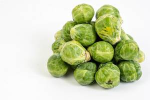 Fresh raw healthy Brussel Sprouts above white background