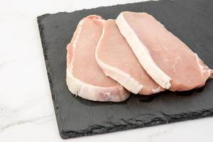 Fresh Raw Pork Chops on the stone tray (Flip 2019)