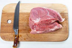 Fresh raw pork meat on kitchen board with knife (Flip 2019)