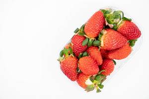 Fresh Raw Strawberries above white background with copy space