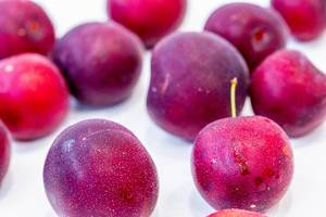 Fresh ripe plums on white background (Flip 2019)