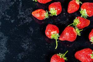 Fresh ripe strawberry on black background