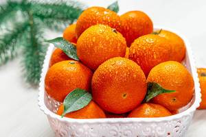 Fresh ripe tangerines with water drops and Christmas tree branches (Flip 2019)