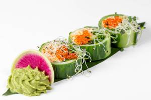 Fresh rolls with cucumber, avocado, crab, arugula and micro greens on a large green leaf with wasabi sauce (Flip 2019)
