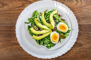 Fresh salad with lettuce, boiled eggs and avocado. Top view (Flip 2019)