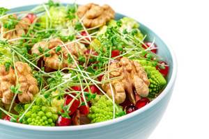 Fresh salad with walnuts, pomegranate and watercress, close-up (Flip 2020)