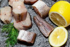Fresh sea fish with lemon slices and dill