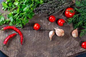 Fresh vegetables and herbs on old wooden background