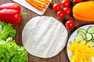 Fresh vegetables and round pita for cooking summer snacks
