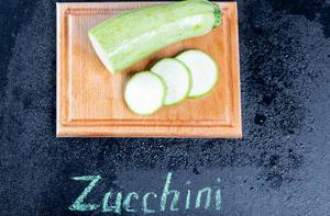Fresh zucchini on the kitchen Board with the inscription