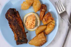 Fried Carp fish served with Potatoes and Salad on the plate (Flip 2019)