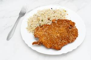 Fried Chicken meat with cooked Rice served on the plate