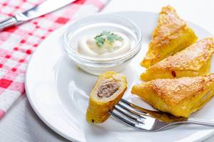 Fried pancakes with meat, triangular shape