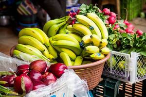 Frische Äpfel, Bananen und Radischen auf dem Markt