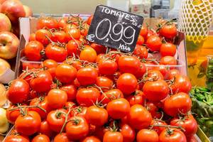 Frische Tomaten, gestapelt an einem Gemüsestand in der Mercat de la Boqueria Markthalle an der Straße La Rambla in Barcelona, Spanien