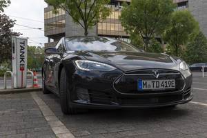 Front view of a black Tesla Model S 90D during charging process at a German TankE charging station of RheinEnergie