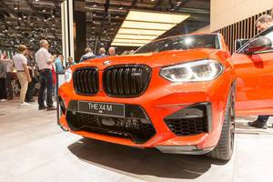 Front view of SUV- Coupé and red sports car BMW x4 M Competition