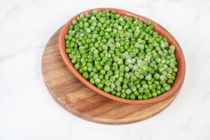 Frozen Green Peas in the bowl above white background