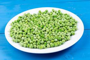 Frozen Green Peas on the white plate (Flip 2019)