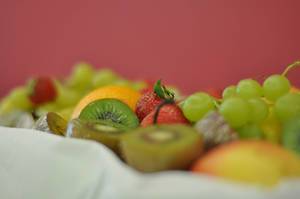 Früchtekorb mit Kiwi, Erdbeeren, Trauben, Orangen und Äpfeln