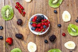 Fruit summer background with berries, kiwi slices and banana