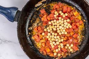 Frying sliced Tomato with Chickpeas in the frying pan (Flip 2019)