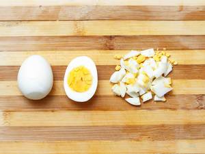 Full egg, half egg and cutted egg on wooden background