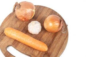 Funny image with Onion Garlic and Carrot on the wooden board (Flip 2019)