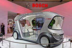 Futuristic road traffic with autonomous concept vehicle: self-driving Bosch IoT shuttle bus, drives with artificial intelligence